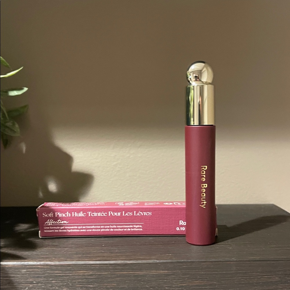 Rare Beauty Soft Pinch Tinted Lip Oil in Affection which is a muted berry shade.